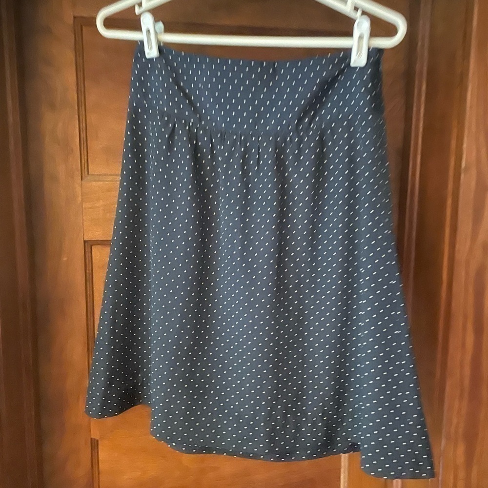 The limited, navy blue polkadot skirt, size extra small